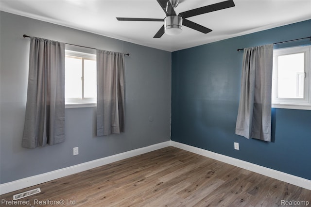 1330 Rahn St, Westland, MI 48186 - unfurnished room featuring healthy amount of natural light, wood finished floors, and a ceiling fan