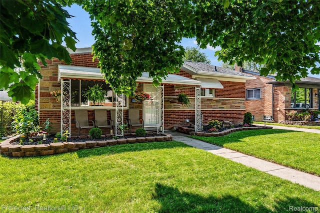 1330 Rahn St, Westland, MI 48186 - view of front of property with a front yard and brick siding