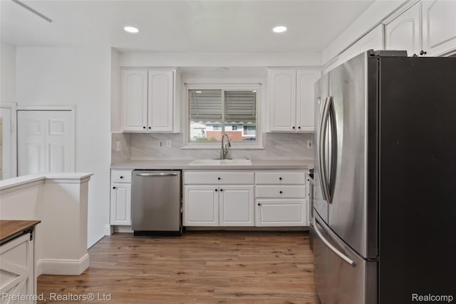 1330 Rahn St, Westland, MI 48186 - kitchen with appliances with stainless steel finishes, light wood-style flooring, tasteful backsplash, light countertops, and recessed lighting