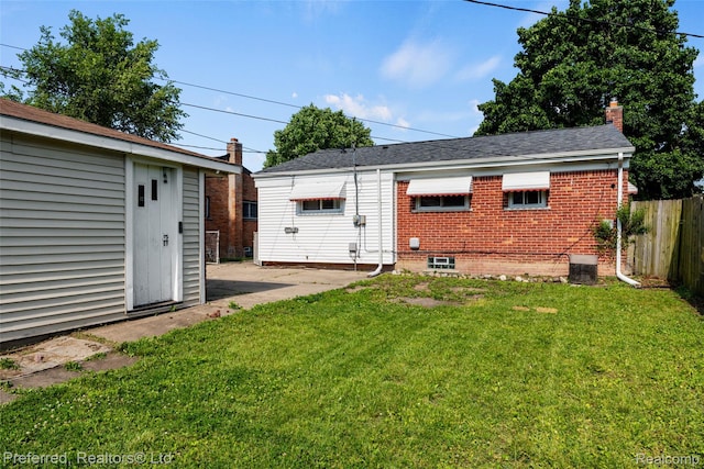 1330 Rahn St, Westland, MI 48186 - rear view of property featuring brick siding and a chimney