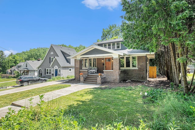 1412 4th St NW, Grand Rapids, MI 49504 - view of front of property with brick siding and a porch