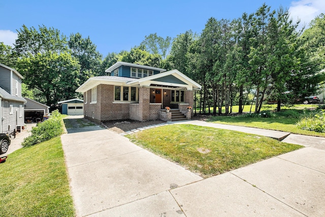 1412 4th St NW, Grand Rapids, MI 49504 - view of front of property featuring brick siding, an outdoor structure, a front lawn, and a porch