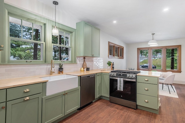 1412 4th St NW, Grand Rapids, MI 49504 - kitchen featuring green cabinetry, stainless steel appliances, dark wood-style flooring, backsplash, and recessed lighting