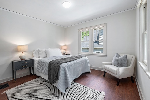 1412 4th St NW, Grand Rapids, MI 49504 - bedroom with dark wood-style floors and crown molding
