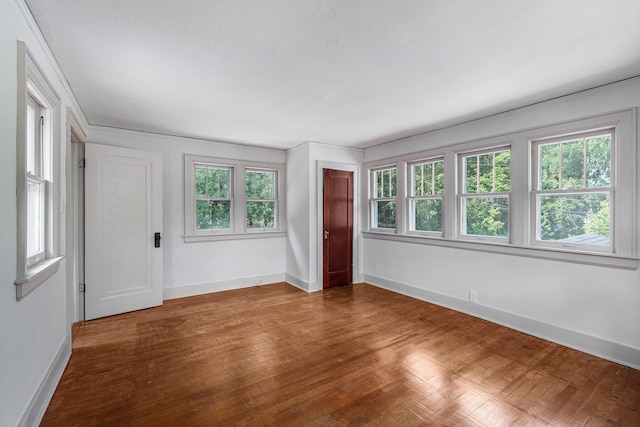 1412 4th St NW, Grand Rapids, MI 49504 - spare room featuring baseboards and wood finished floors