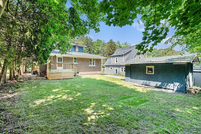 1412 4th St NW, Grand Rapids, MI 49504 - rear view of house featuring a yard and a wooden deck