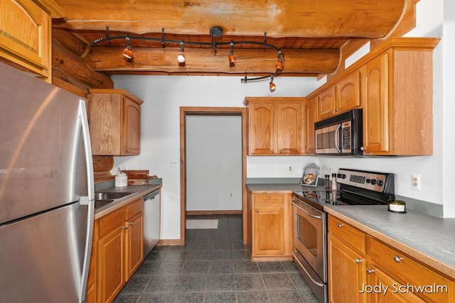 5820 Grace Hwy, Sunfield, MI 48890 - kitchen with appliances with stainless steel finishes, dark tile patterned flooring, brown cabinets, dark countertops, and beam ceiling