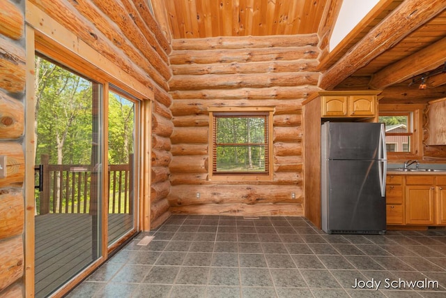 5820 Grace Hwy, Sunfield, MI 48890 - kitchen with freestanding refrigerator, rustic walls, wooden ceiling, dark tile patterned floors, and light brown cabinets