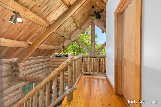 5820 Grace Hwy, Sunfield, MI 48890 - corridor with rustic walls, wooden ceiling, light wood-style floors, and an upstairs landing