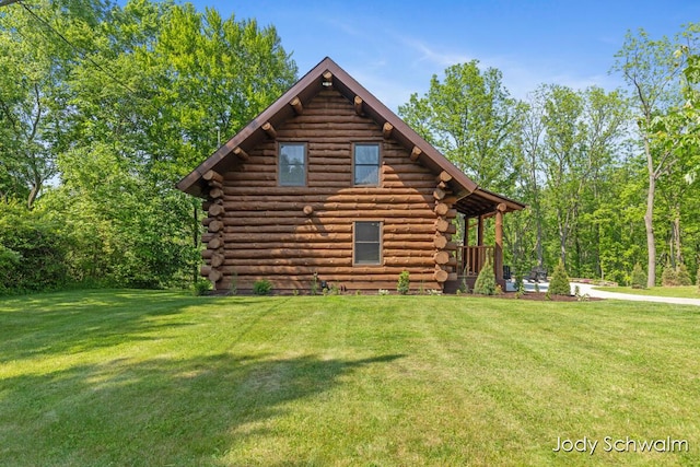 5820 Grace Hwy, Sunfield, MI 48890 - view of front of property with log exterior and a front lawn