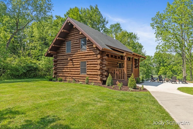 5820 Grace Hwy, Sunfield, MI 48890 - view of front facade with log siding and a front lawn