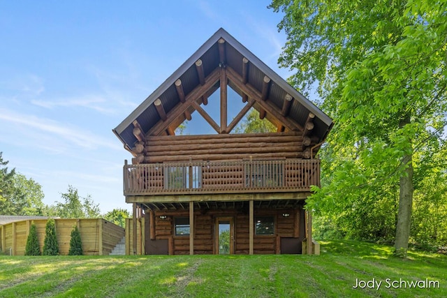 5820 Grace Hwy, Sunfield, MI 48890 - rear view of property featuring log siding, a wooden deck, and a yard