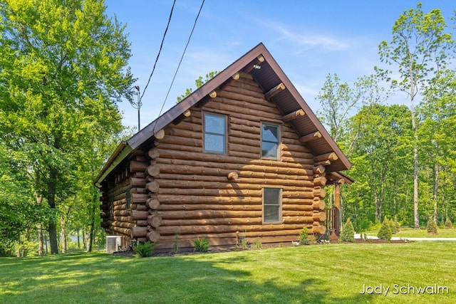 5820 Grace Hwy, Sunfield, MI 48890 - view of side of home featuring log siding and a yard