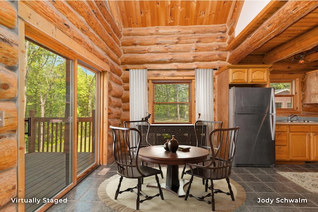 5820 Grace Hwy, Sunfield, MI 48890 - dining area with log walls, wood ceiling, and dark tile patterned floors