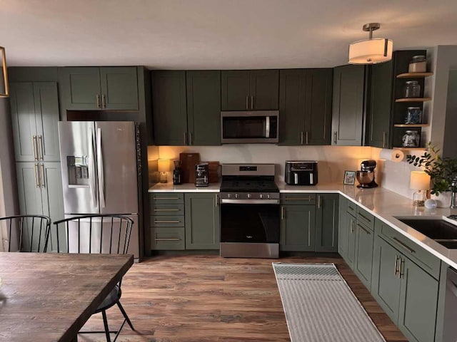 1131 Odell Farm Ln, Vicksburg, MI 49097 - kitchen featuring stainless steel appliances, wood finished floors, green cabinets, and light countertops