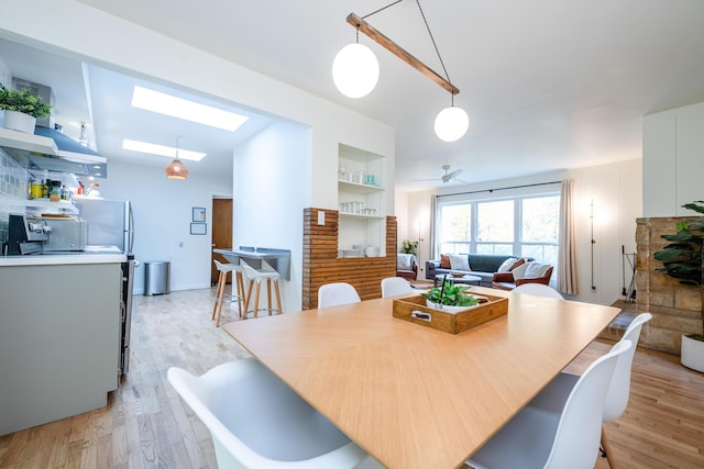 212 N Maple St, Saugatuck, MI 49453 - dining room with a skylight, light wood finished floors, and a ceiling fan