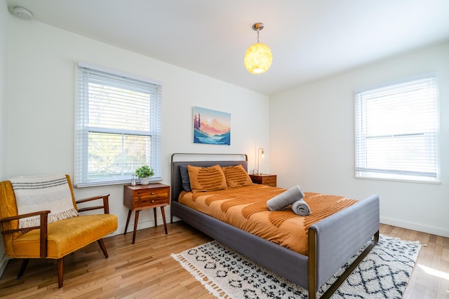 212 N Maple St, Saugatuck, MI 49453 - bedroom featuring multiple windows and light wood-style flooring