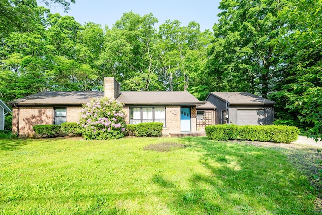 212 N Maple St, Saugatuck, MI 49453 - view of front of property with brick siding, a chimney, and a front lawn