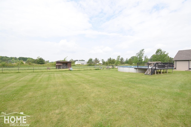 2411 Escott Rd, Owosso, MI 48867 - view of yard with an outdoor pool