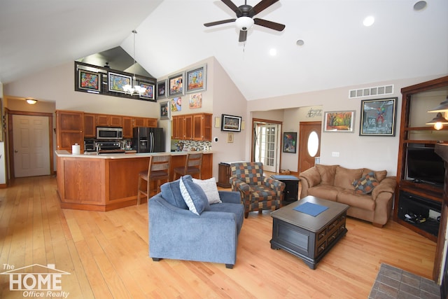 2411 Escott Rd, Owosso, MI 48867 - living area with high vaulted ceiling, a ceiling fan, and light wood finished floors