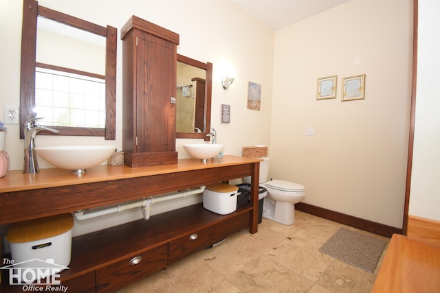 2411 Escott Rd, Owosso, MI 48867 - bathroom featuring double vanity and toilet