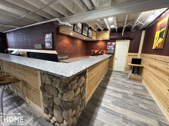 2411 Escott Rd, Owosso, MI 48867 - indoor dry bar with wood walls, wainscoting, and wood finished floors