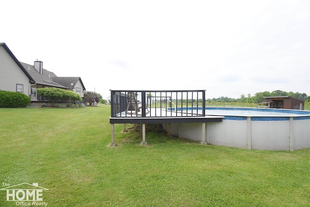 2411 Escott Rd, Owosso, MI 48867 - outdoor pool with a yard and a wooden deck