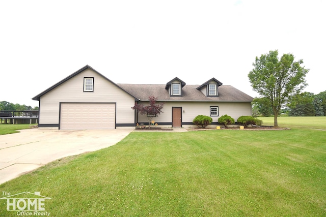 2411 Escott Rd, Owosso, MI 48867 - new england style home with a front lawn, concrete driveway, and a garage