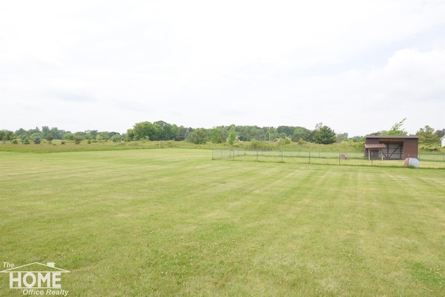 2411 Escott Rd, Owosso, MI 48867 - view of yard featuring a view of countryside and an outbuilding