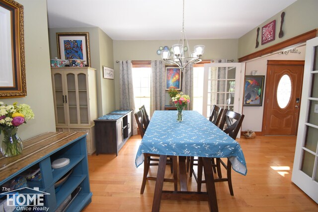 2411 Escott Rd, Owosso, MI 48867 - dining area featuring a chandelier and light wood-type flooring