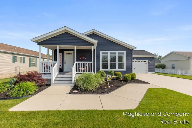 5231 E Scenic Turn Ln, Holland, MI 49423 - view of front facade featuring a porch, driveway, and a garage