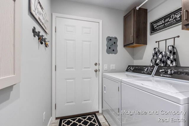 5231 E Scenic Turn Ln, Holland, MI 49423 - laundry room with cabinet space, independent washer and dryer, and light wood-style floors