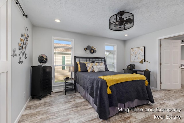 5231 E Scenic Turn Ln, Holland, MI 49423 - bedroom featuring a textured ceiling, light wood-type flooring, and recessed lighting