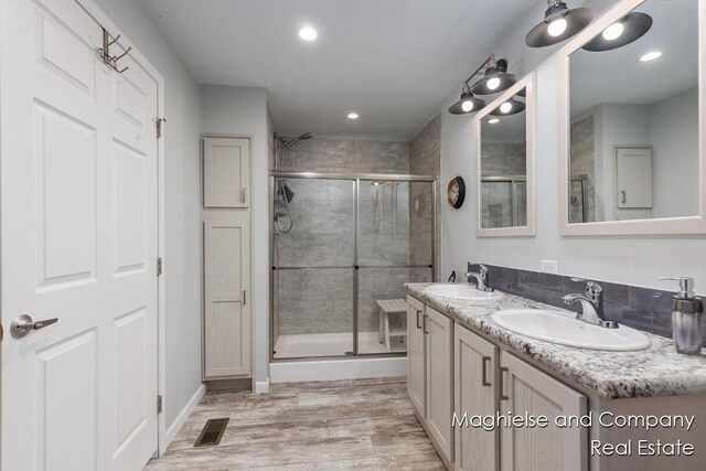 5231 E Scenic Turn Ln, Holland, MI 49423 - full bath with a shower stall, wood finished floors, double vanity, and recessed lighting