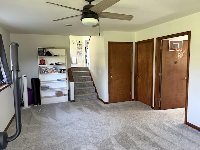 11199 Edgewood Rd, Bellevue, MI 49021 - unfurnished living room with ceiling fan, carpet flooring, and stairs