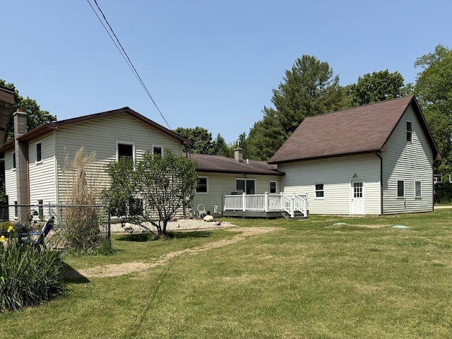 11199 Edgewood Rd, Bellevue, MI 49021 - rear view of property featuring a wooden deck and a chimney