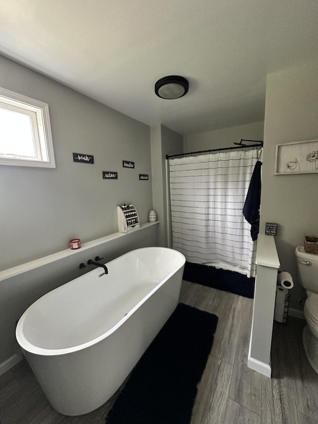 11199 Edgewood Rd, Bellevue, MI 49021 - bathroom with a freestanding tub and wood finished floors