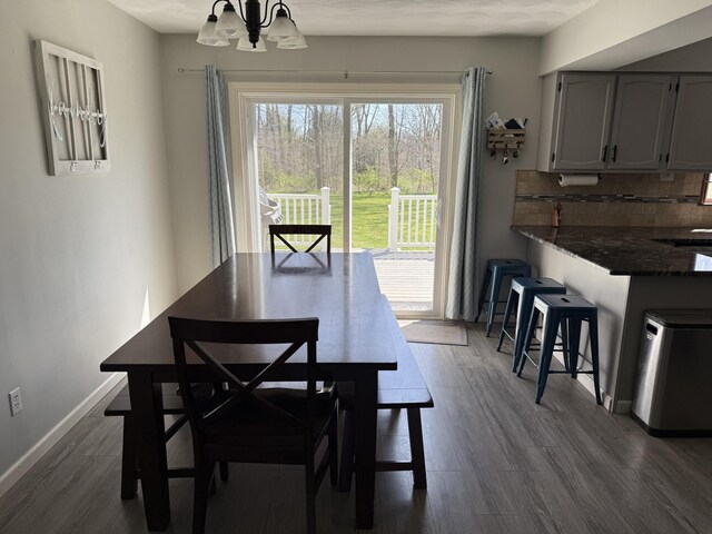 11199 Edgewood Rd, Bellevue, MI 49021 - dining space featuring a chandelier and dark wood-style floors