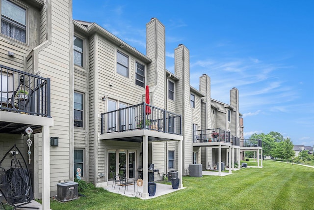 3395 Breckland Ct, Ann Arbor, MI 48108 - rear view of house with a balcony, a yard, and a patio