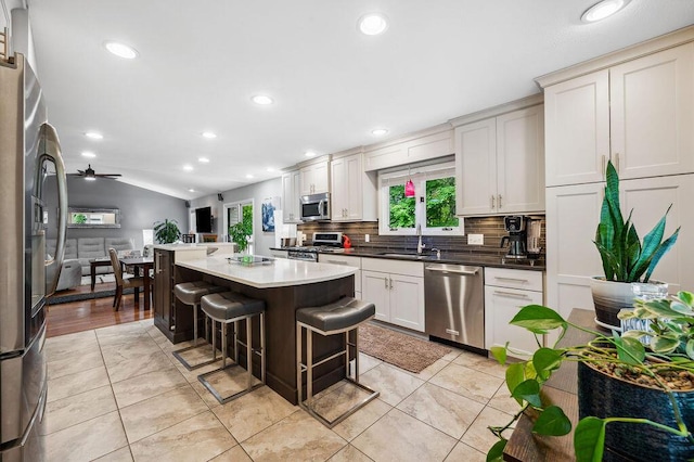 3999 Ravina Ter, Saint Joseph, MI 49085 - kitchen featuring stainless steel appliances, recessed lighting, backsplash, a breakfast bar, and vaulted ceiling
