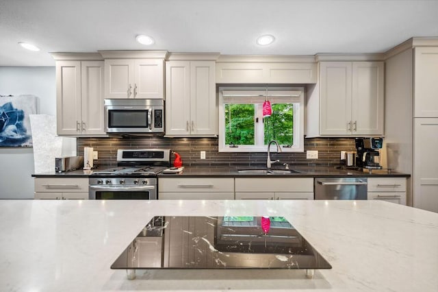 3999 Ravina Ter, Saint Joseph, MI 49085 - kitchen with appliances with stainless steel finishes, dark stone countertops, decorative backsplash, and recessed lighting