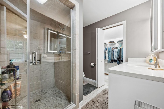 3999 Ravina Ter, Saint Joseph, MI 49085 - bathroom featuring vanity, a shower stall, tile patterned flooring, and a walk in closet