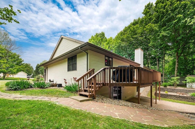 3999 Ravina Ter, Saint Joseph, MI 49085 - back of property featuring a deck, a chimney, and a yard