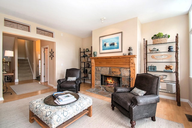 18418 Dunecrest Dr Unit 9, New Buffalo, MI 49117 - living area with light wood-style flooring, a stone fireplace, and stairway