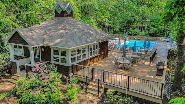 18418 Dunecrest Dr Unit 9, New Buffalo, MI 49117 - back of house featuring a shingled roof, a deck, and outdoor dining area