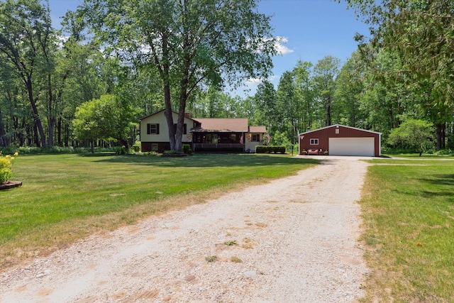 10343 N Walnut Ave, Bitely, MI 49309 - tri-level home featuring an outbuilding, a garage, a front yard, and dirt driveway