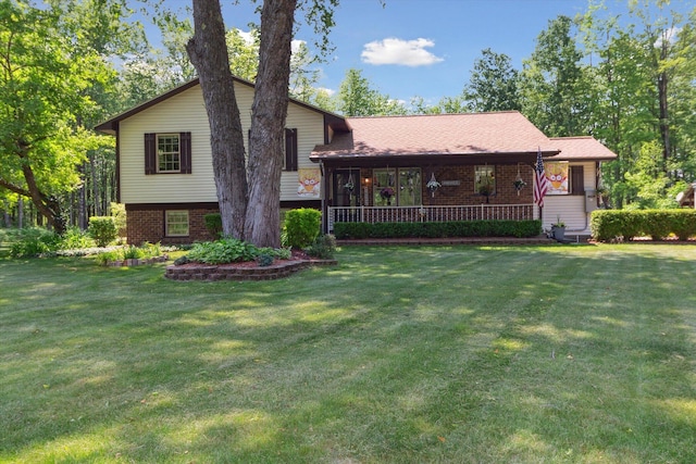 10343 N Walnut Ave, Bitely, MI 49309 - split level home featuring brick siding, a front yard, and a porch