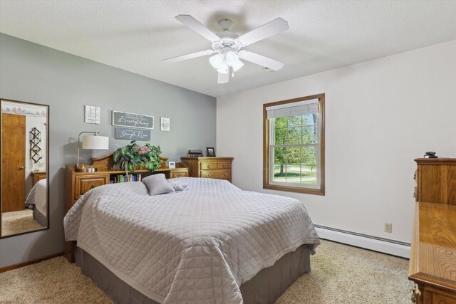 10343 N Walnut Ave, Bitely, MI 49309 - carpeted bedroom featuring a baseboard radiator and a ceiling fan
