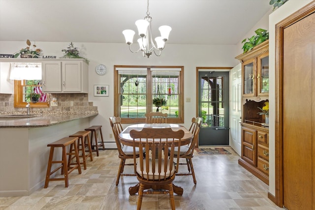 10343 N Walnut Ave, Bitely, MI 49309 - dining area featuring stone finish flooring and a chandelier