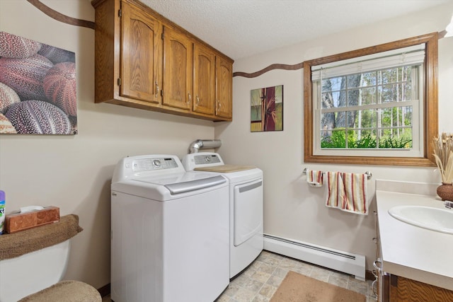 10343 N Walnut Ave, Bitely, MI 49309 - laundry area with baseboard heating, washer and clothes dryer, and cabinet space